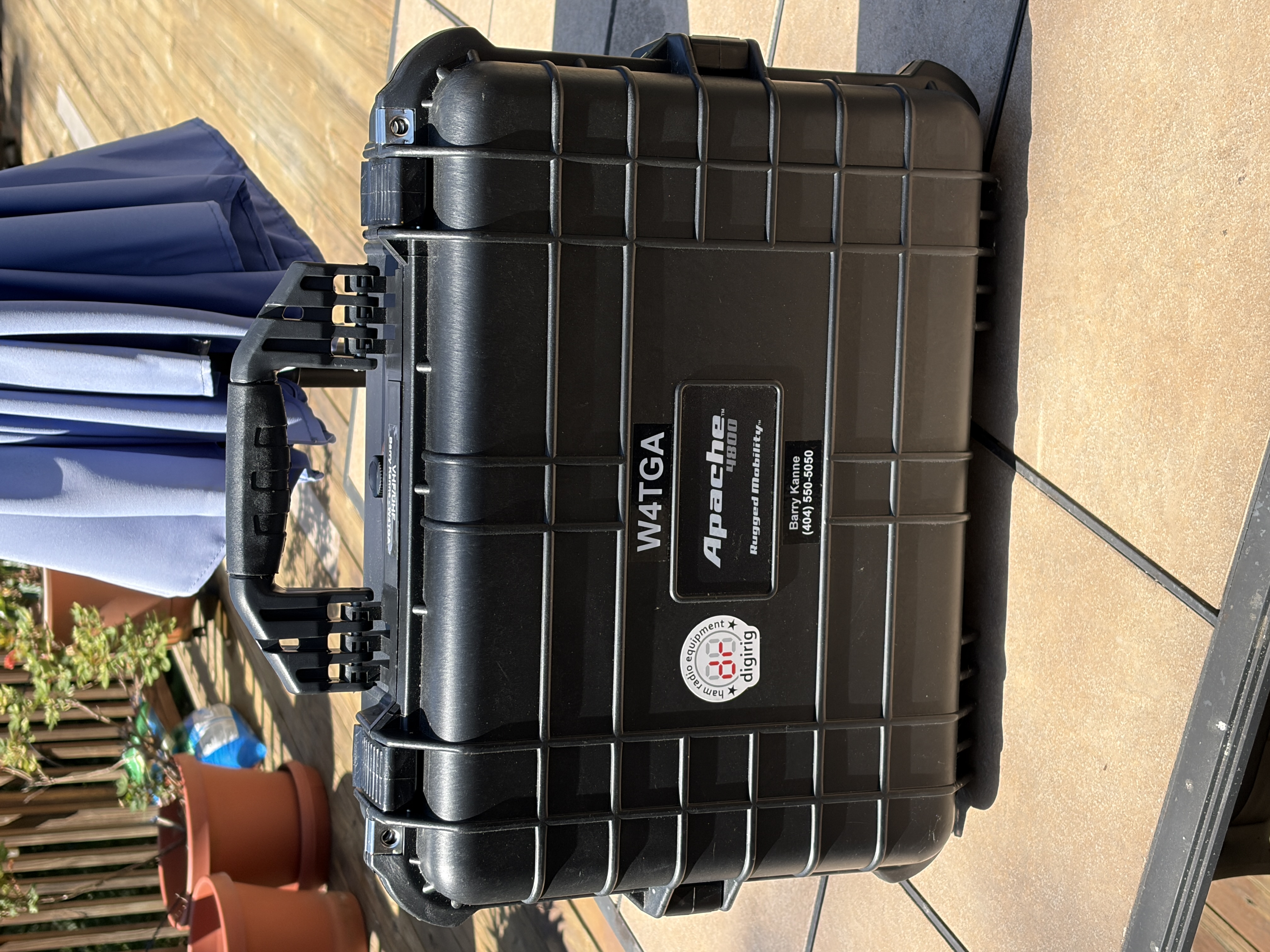 W4TGA's go-kit closed — a black Apache 4800 hard case with the W4TGA callsign and a Digirig sticker on the lid.